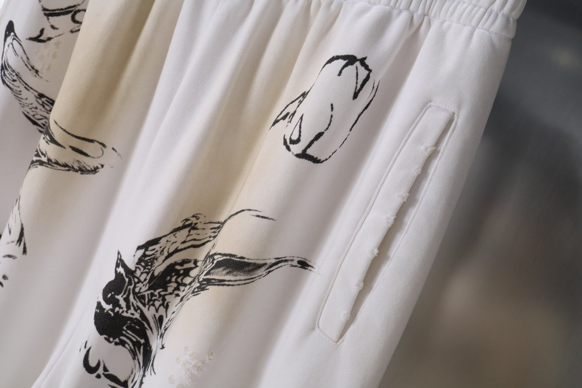 White graphic-print pants with side pocket and stitched panel detail