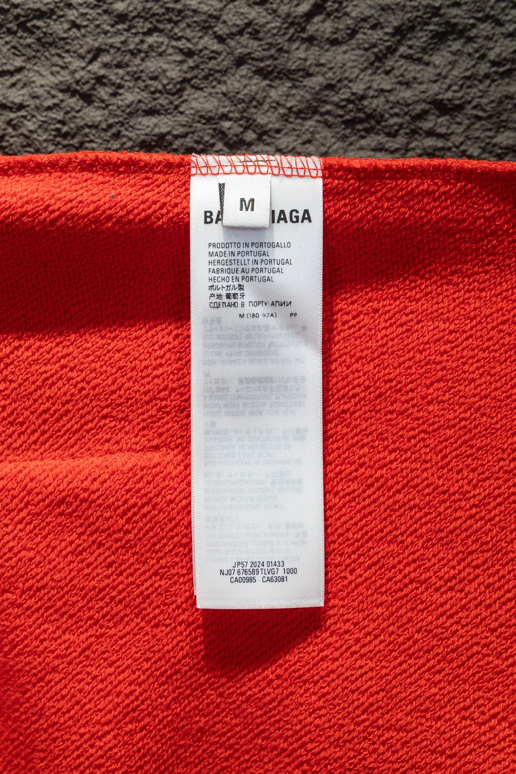 Red hoodie interior size label tag at collar