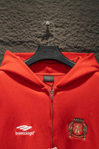 Red zip hoodie close-up, hood and front crest patch