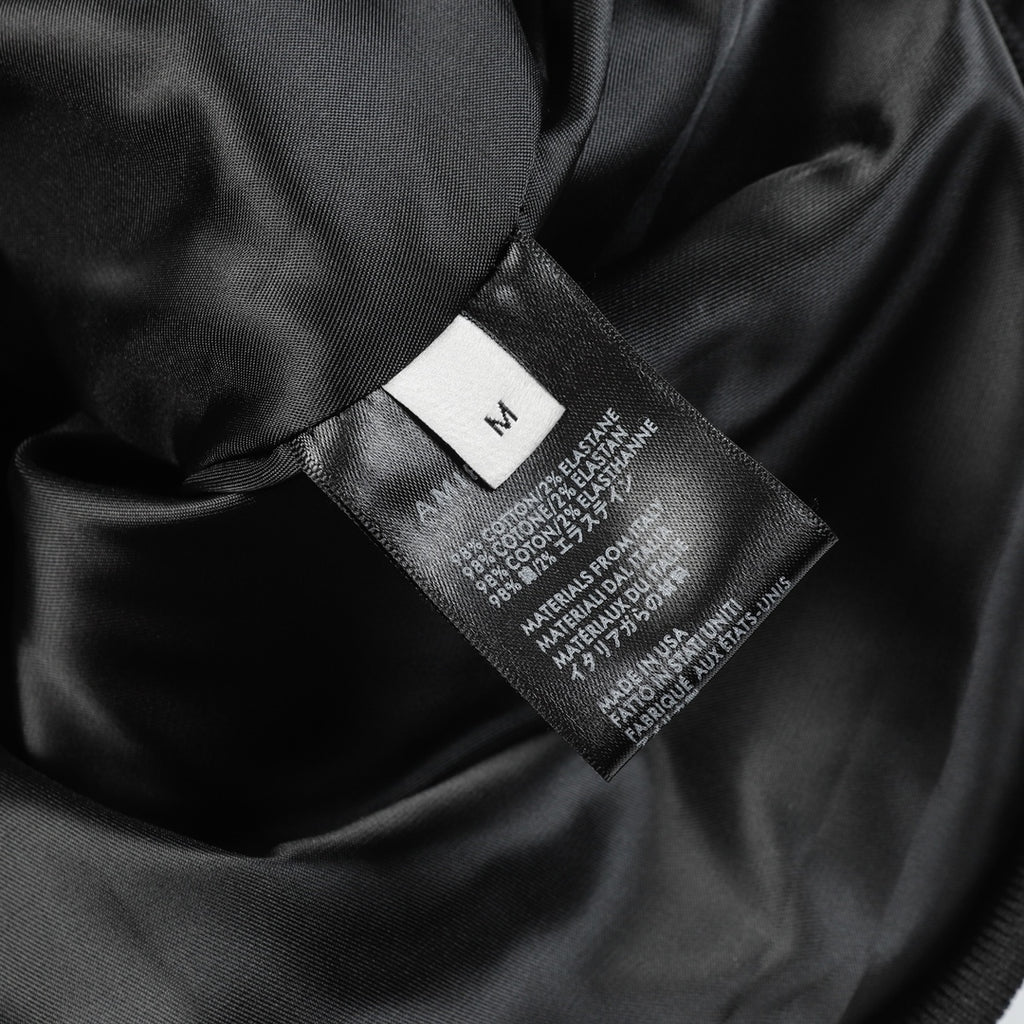 Black fabric interior with size label and printed fabric composition information