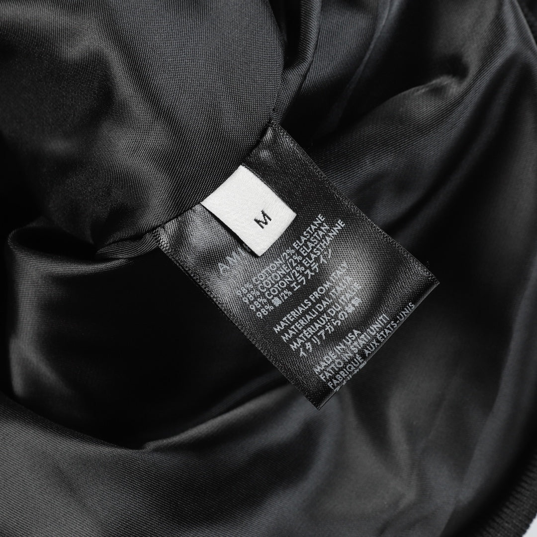 Black fabric interior with size label and printed fabric composition information