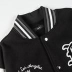 Black varsity jacket close-up with striped ribbed collar and snap button placket