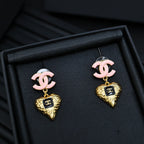Gold-tone heart charm earrings with pink CC studs