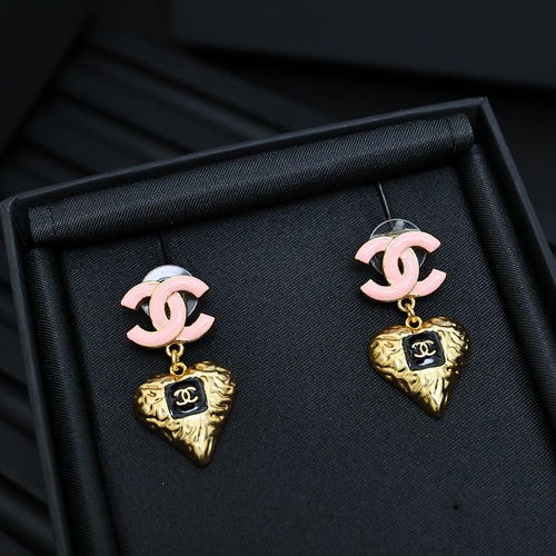 Gold-tone heart charm earrings with pink CC studs