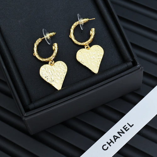Gold-tone heart drop earrings with pink enamel logo, shown in a black box.
