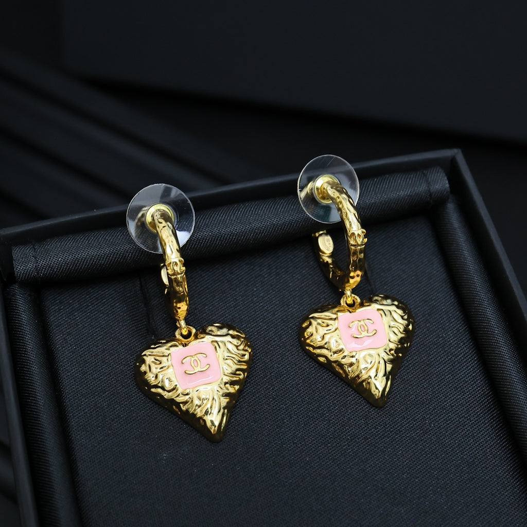 Gold-tone heart drop earrings with pink enamel logo, on hinged hoop hooks.