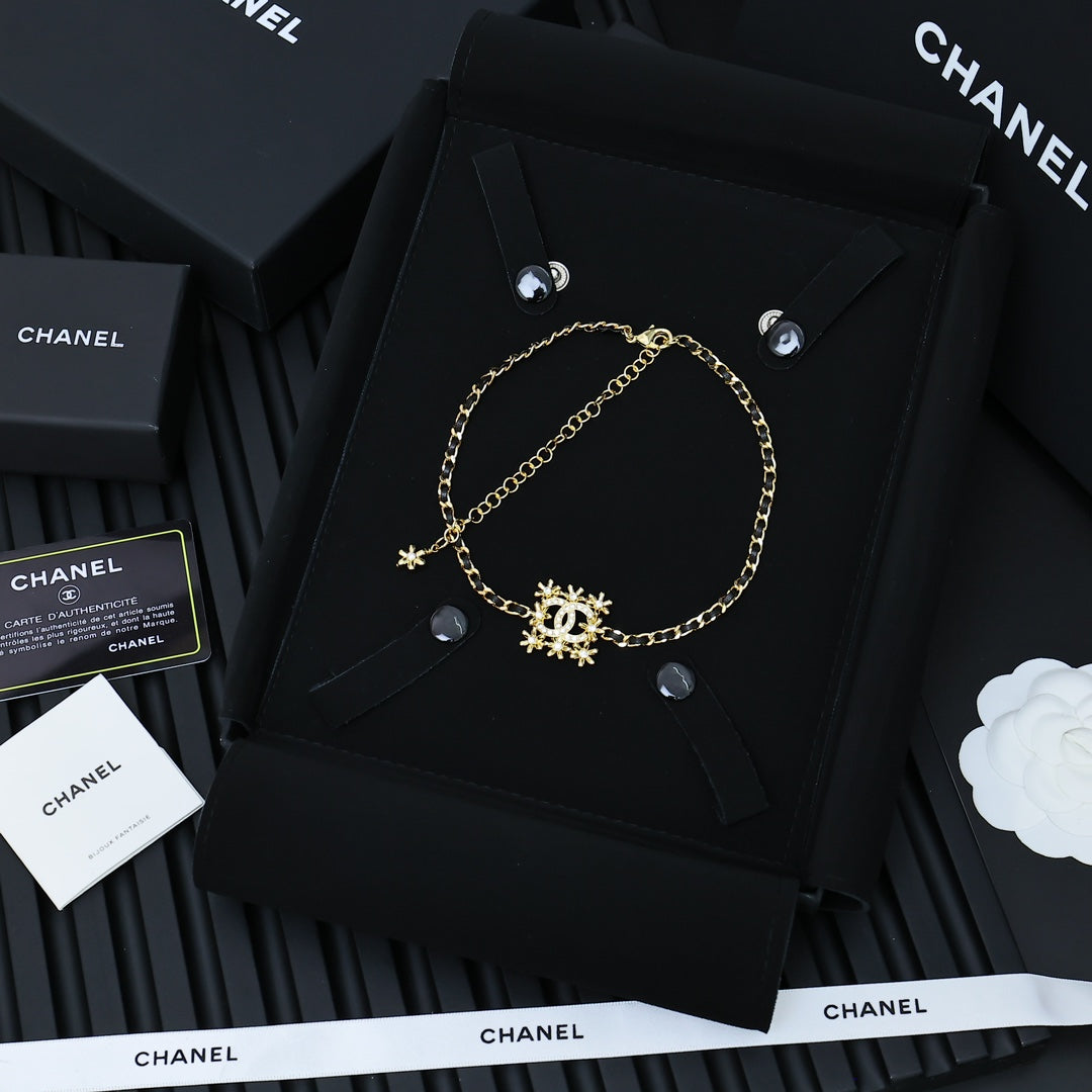 Gold-tone Chanel necklace with snowflake charms on linked chain