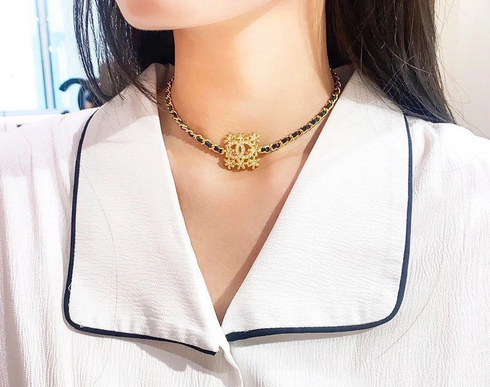 Gold-tone Chanel necklace with round floral CC medallion at collar