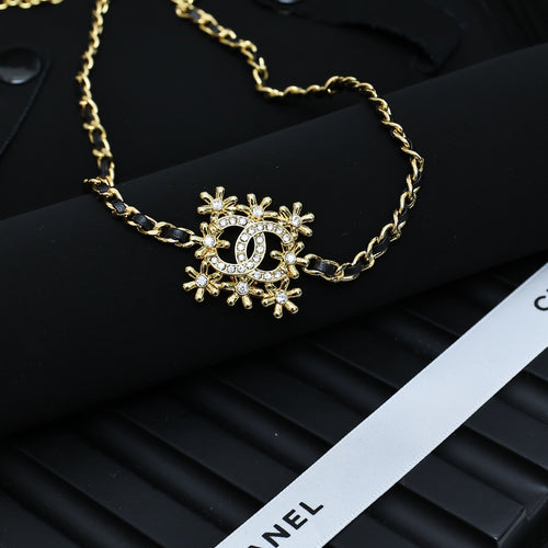 Gold-tone Chanel necklace with snowflake starburst pendant on chain