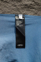 Care label inside light blue long-sleeve shirt collar with brand text
