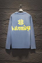 Light blue long-sleeve shirt with yellow and blue Balenciaga logo on the back