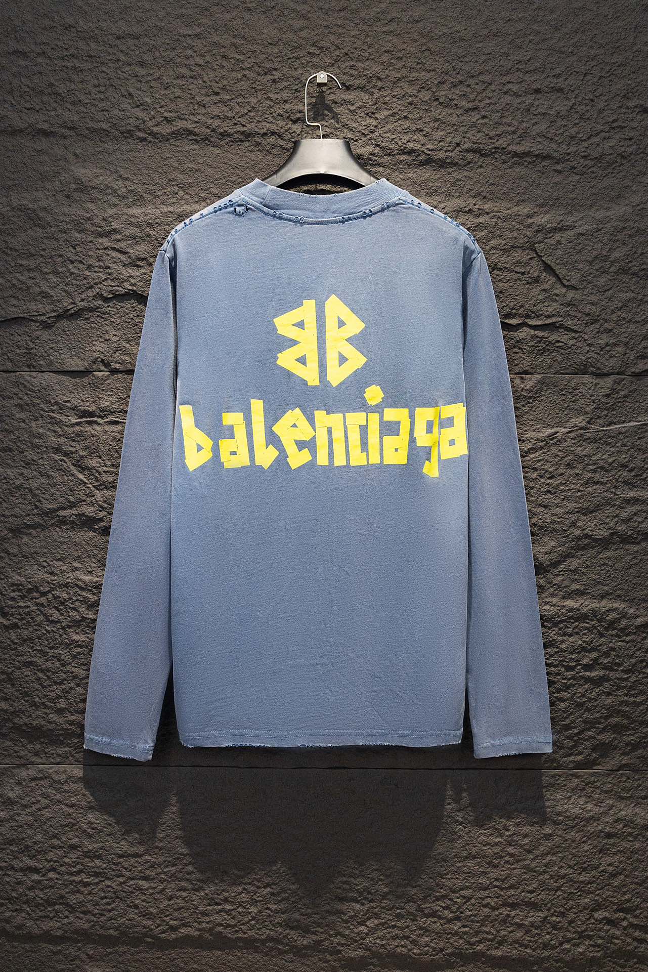 Light blue long-sleeve shirt with yellow and blue Balenciaga logo on the back