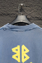 Light blue long-sleeve shirt back upper area with yellow logo graphic