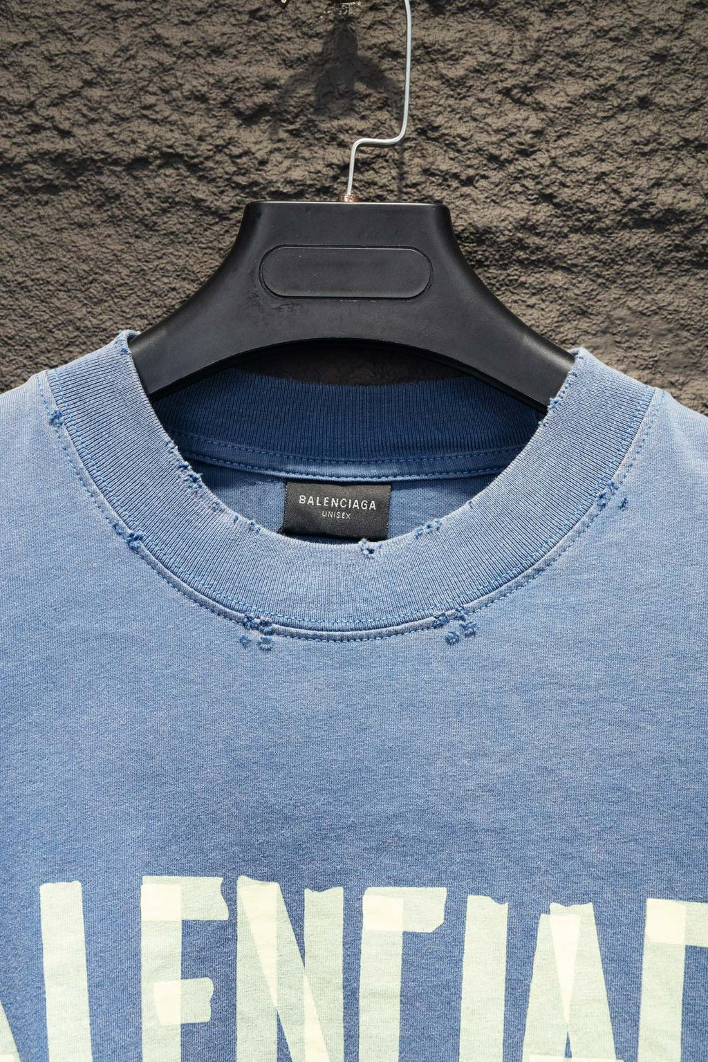 Light blue long-sleeve shirt neckline with small logo embroidery detail