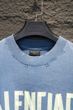Light blue long-sleeve shirt neckline with small logo embroidery detail