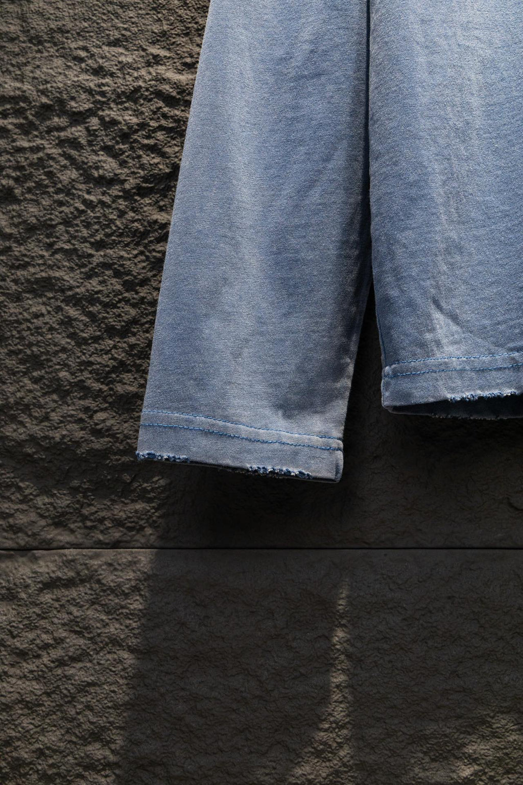 Light blue long-sleeve shirt sleeve hems with folded cuffs