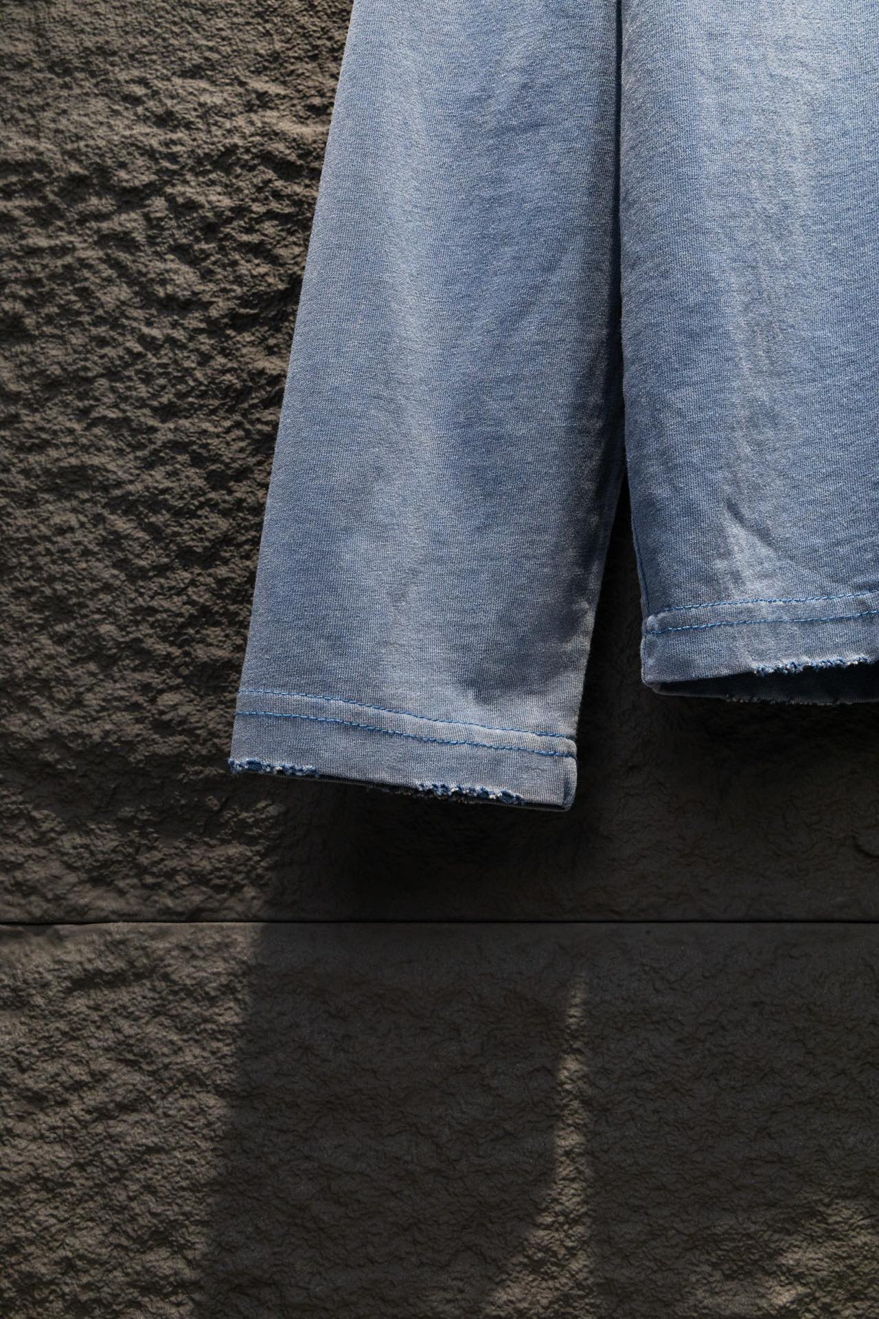 Light blue long-sleeve shirt sleeve hems with folded cuffs