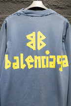 Light blue long-sleeve shirt back with yellow Balenciaga graphic and logo