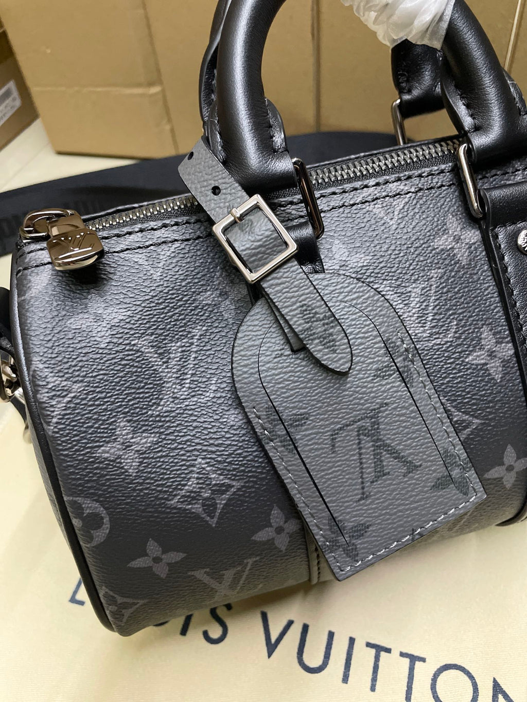 Louis Vuitton monogram satchel bag, dark gray, front buckle and tassel charm