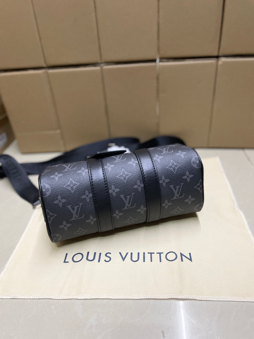 Louis Vuitton monogram satchel bag, dark gray, angled side with shoulder strap