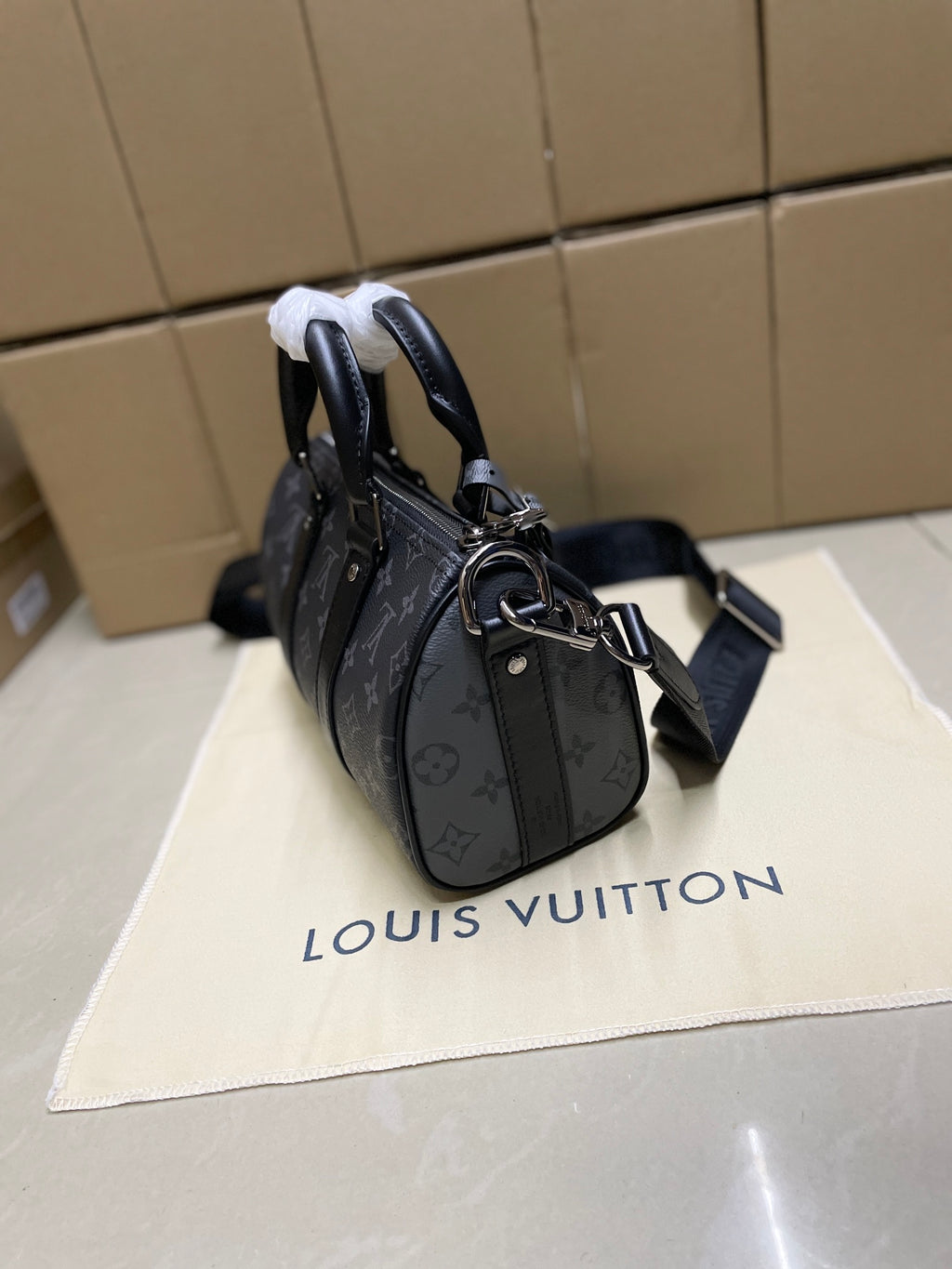 Louis Vuitton monogram satchel bag, dark gray, side profile with shoulder strap