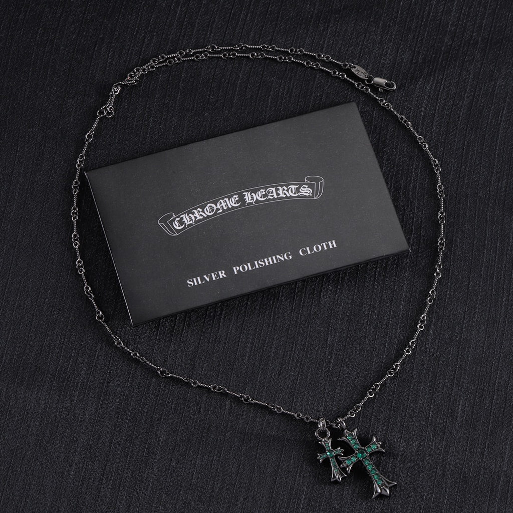 Chrome Hearts silver polishing cloth with silver-tone cross pendant necklace and green stones