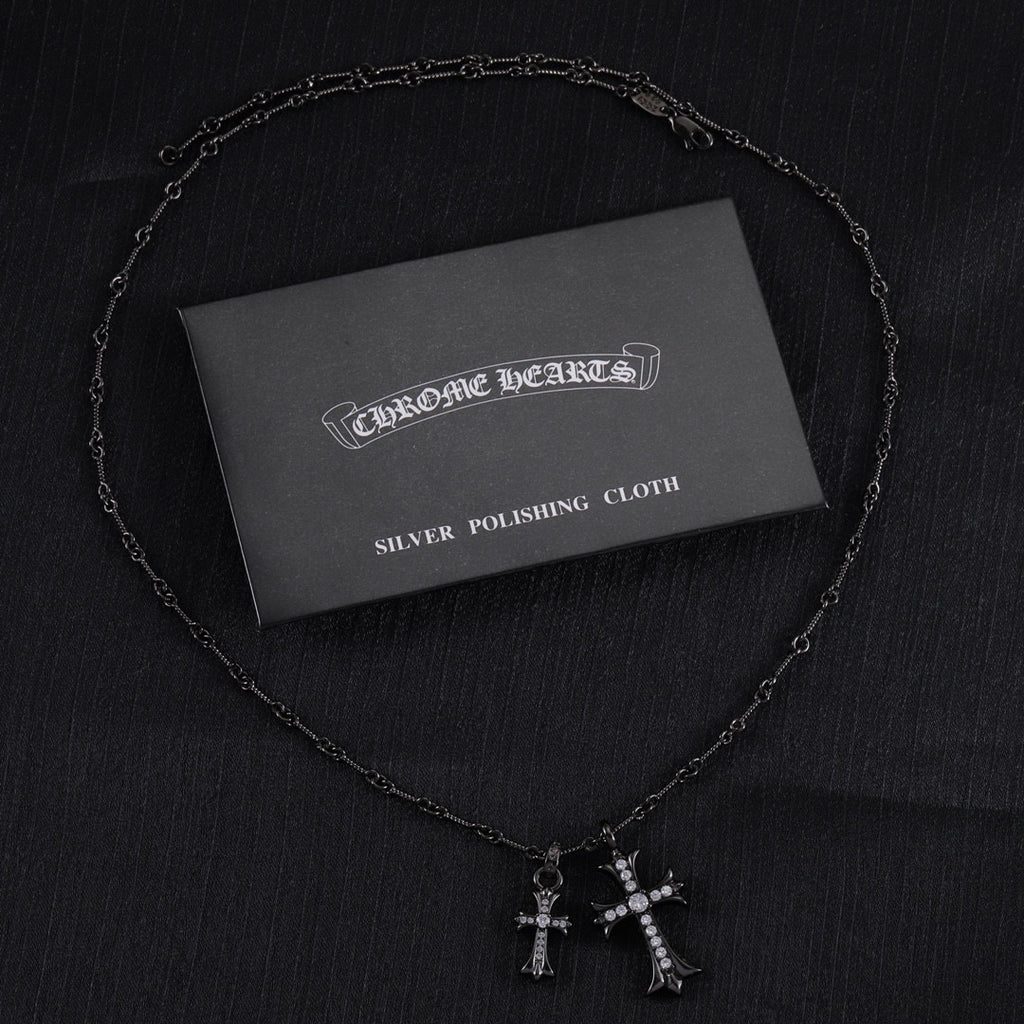 Chrome Hearts silver polishing cloth with silver-tone cross pendant necklace and pink stones