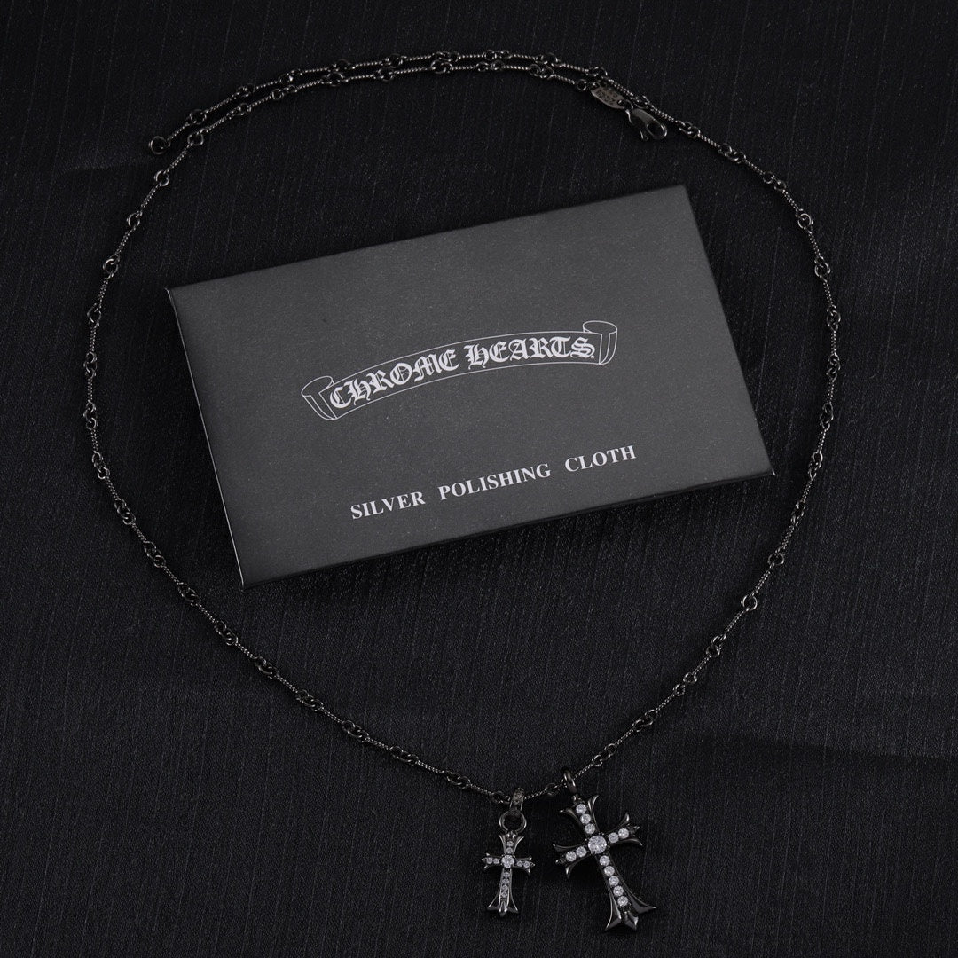 Chrome Hearts silver polishing cloth with silver-tone cross pendant necklace and pink stones