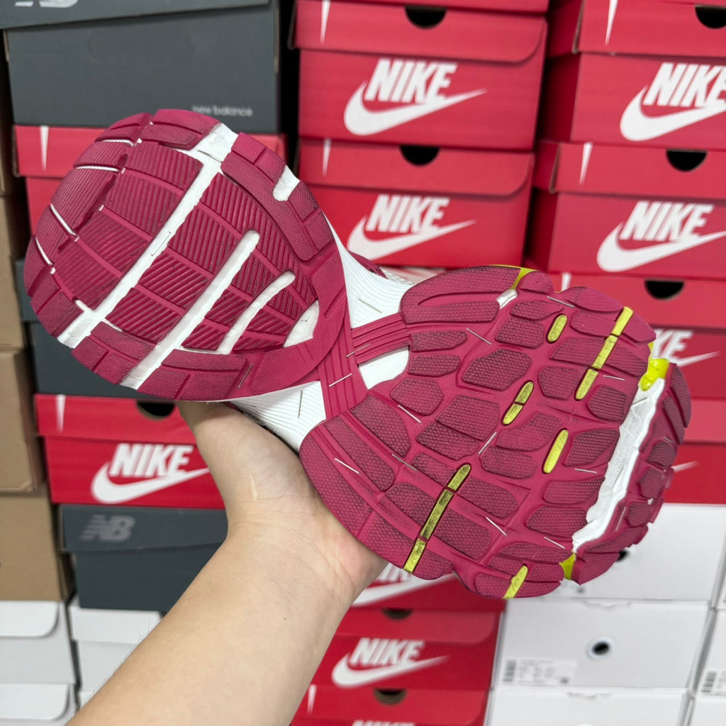 Bottom views of two sneakers with maroon tread and white outsole segments