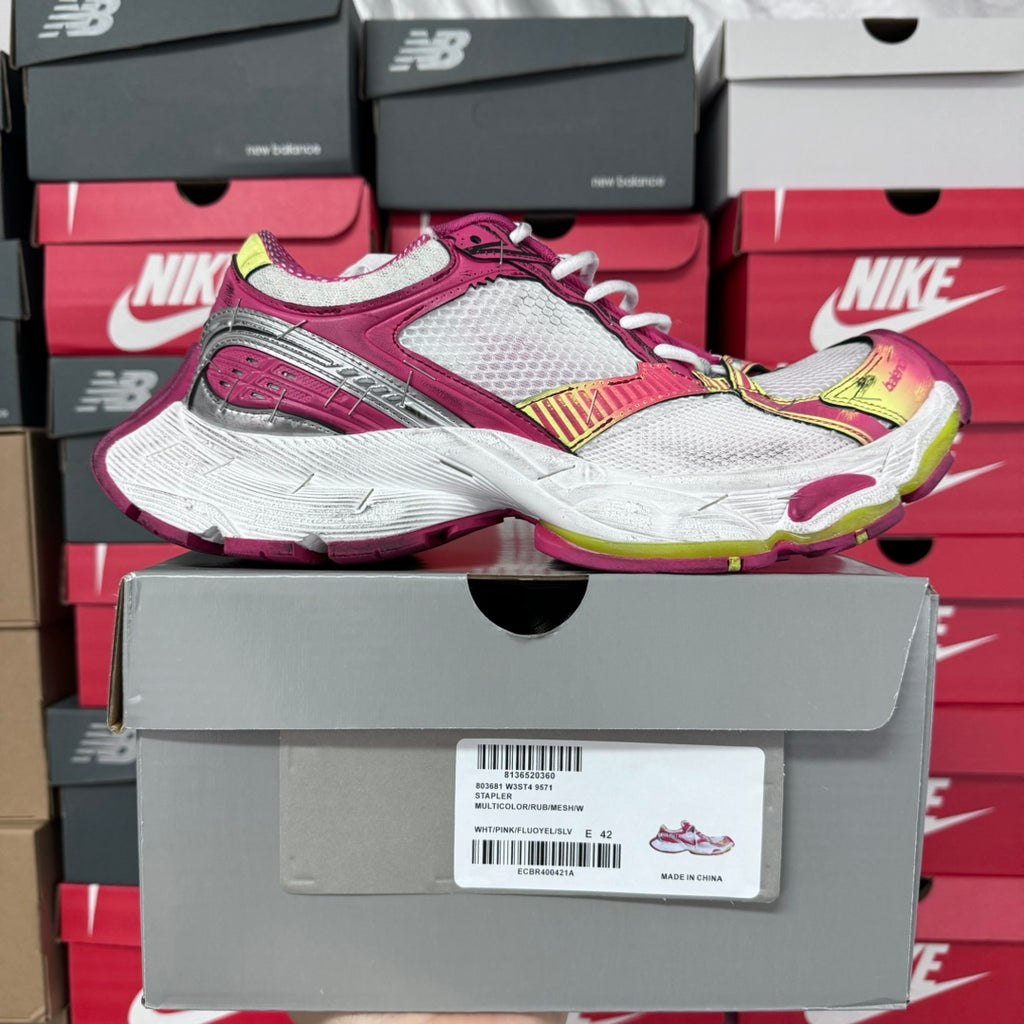 Side view of pink and white lace-up sneakers with gray mesh and multicolor accents