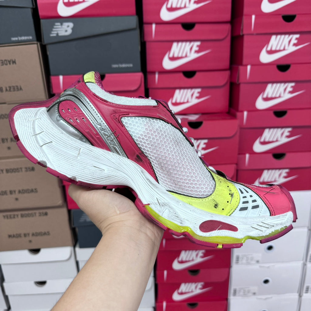 Side view of pink, white, and gray sneakers with lime yellow accents and padded sole