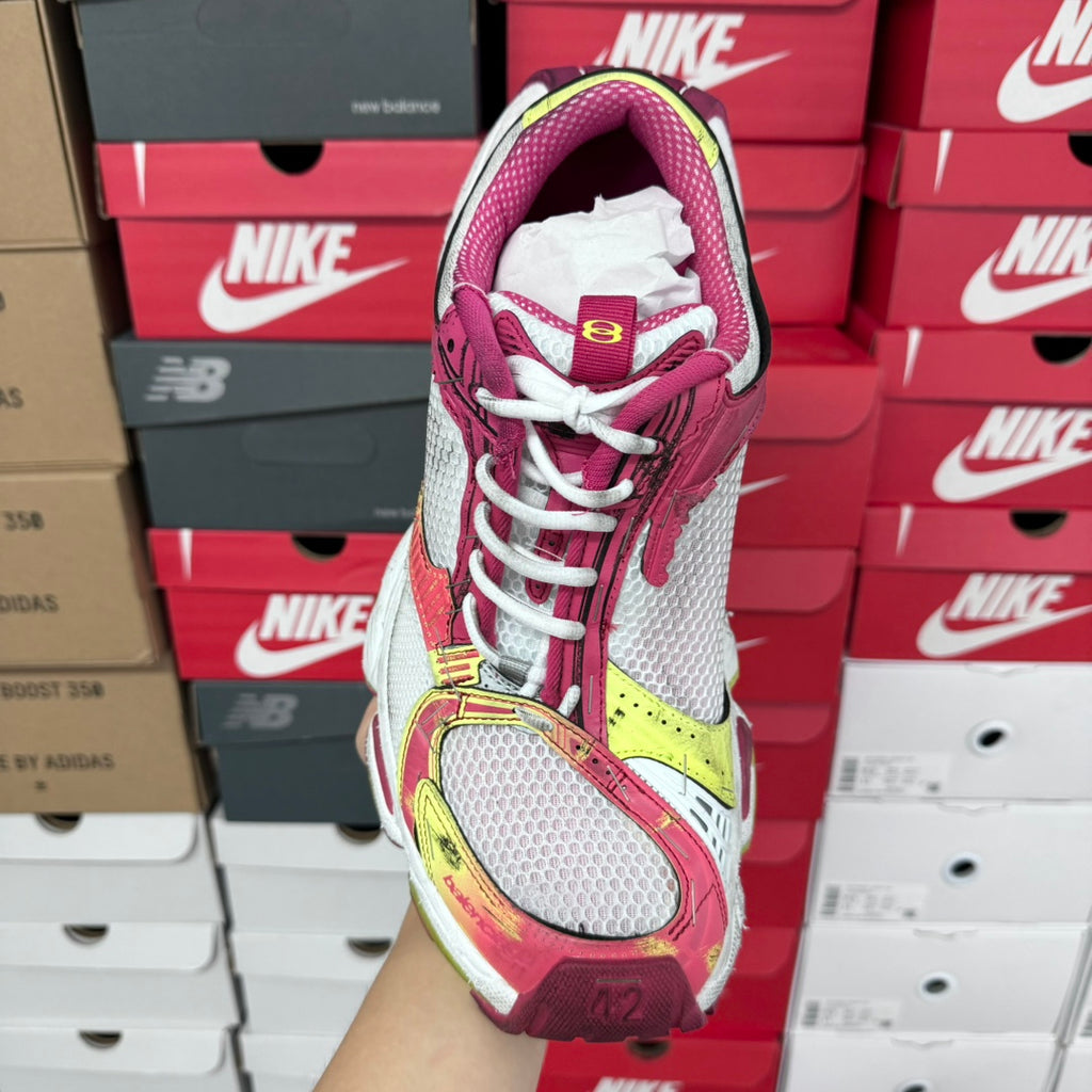 Pink and white lace-up sneakers with mesh panels and multicolor side strap detail