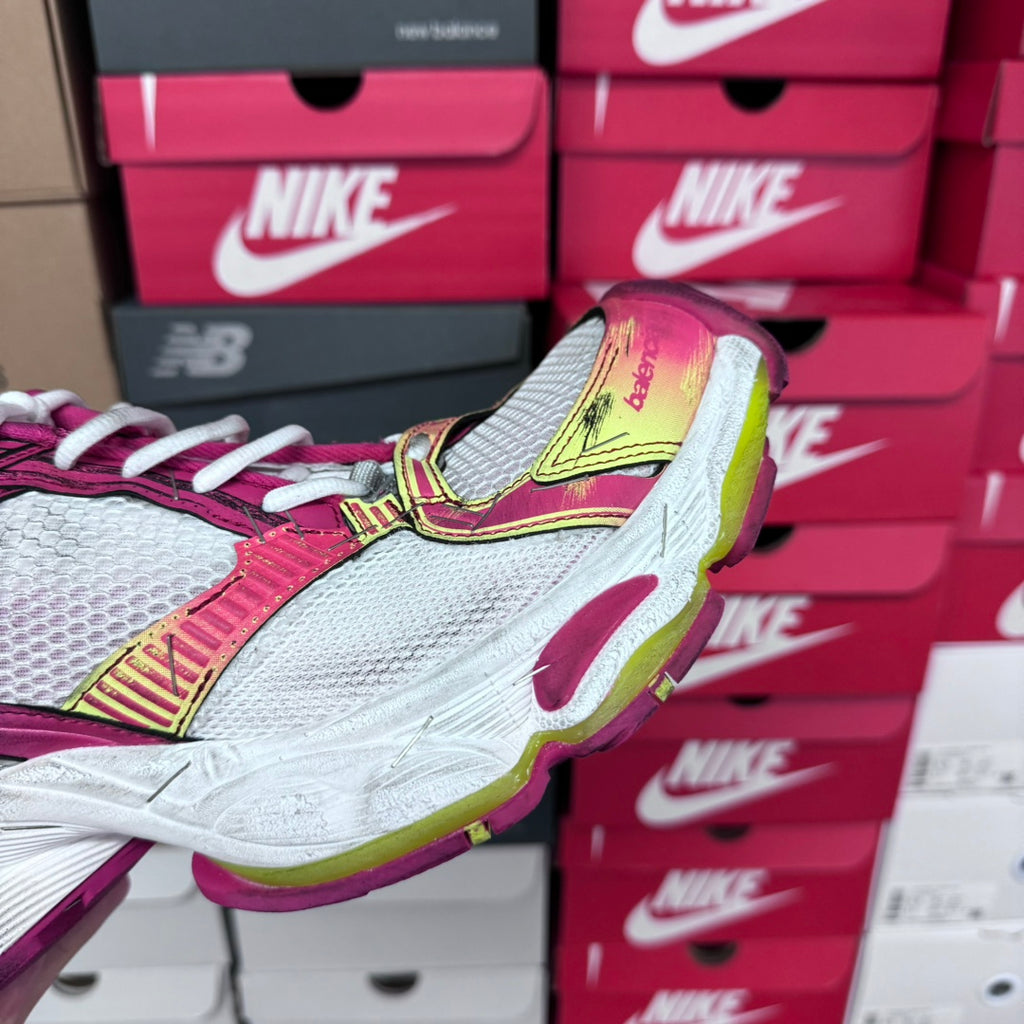 Detail of pink and white lace-up sneaker with gray mesh toe and lime yellow trim