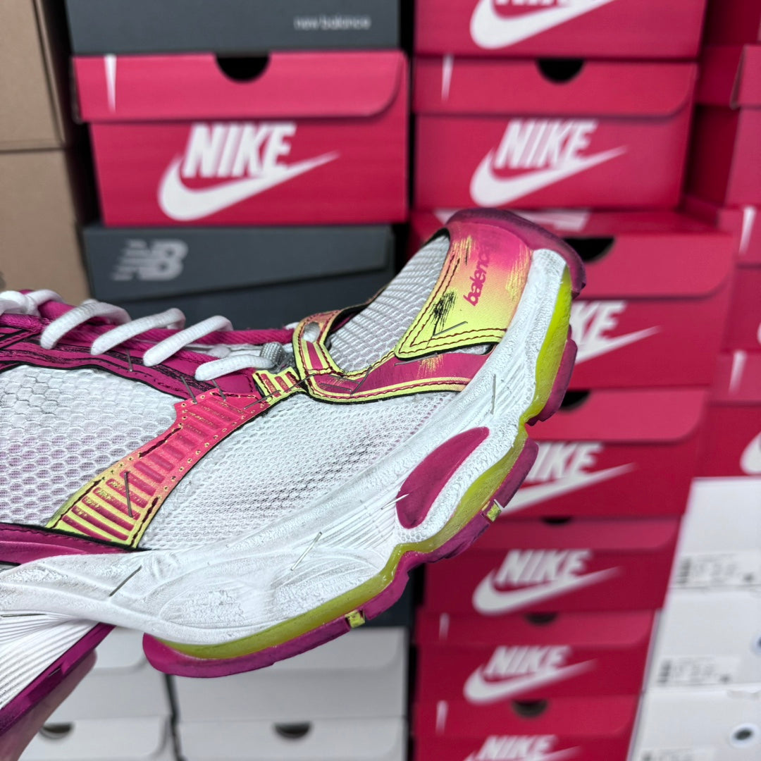 Detail of pink and white lace-up sneaker with gray mesh toe and lime yellow trim