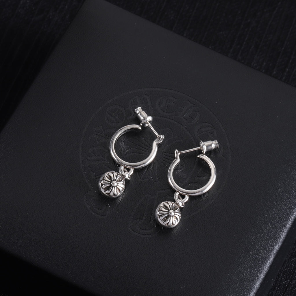 Silver hoop earrings with dangling flower charms and small crossbar detail