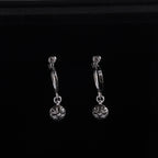 Silver hoop drop earrings with flower charms and linked chain details