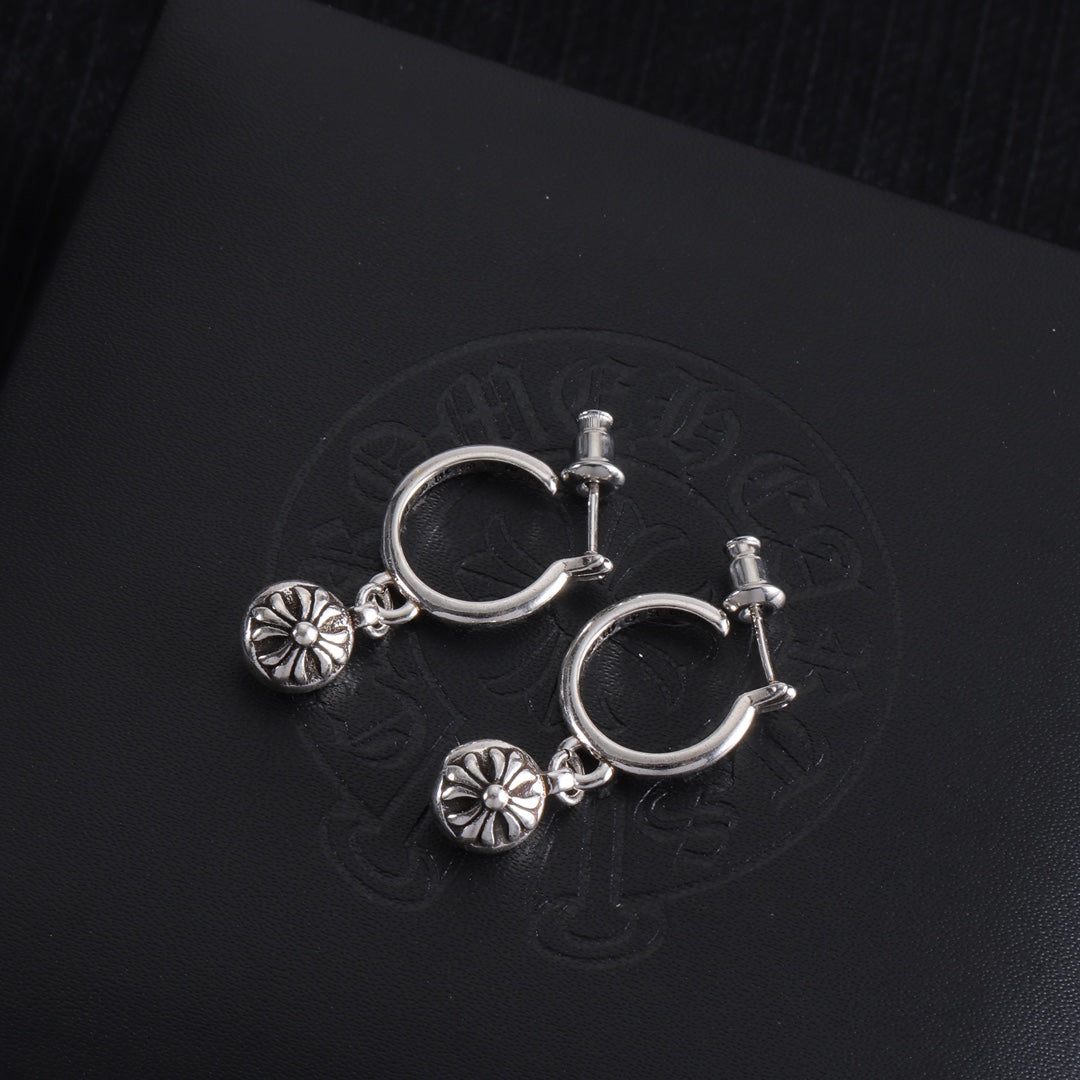 Silver hoop earrings with two dangling flower charms and bar-style clasp posts