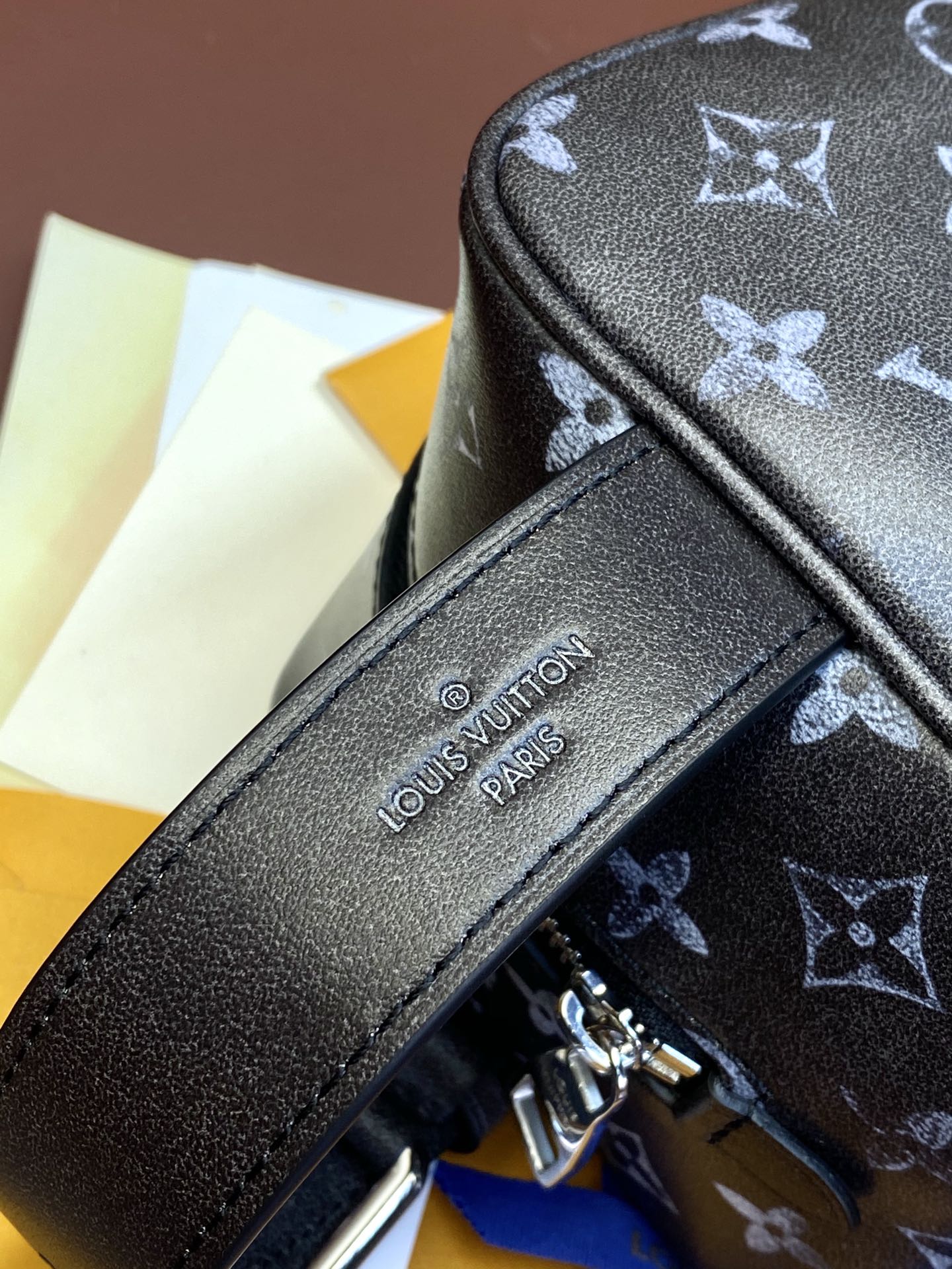 Louis Vuitton monogram bag front patch logo near zipper and top edge