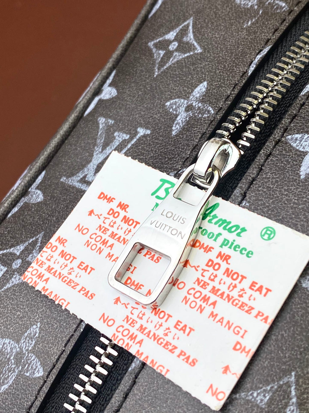 Louis Vuitton monogram zip with metal pull and hanging accessories tags