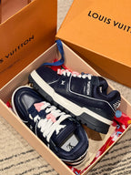 Louis Vuitton navy trainer sneakers displayed in a box with white laces