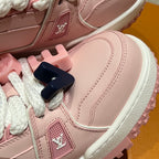 Close-up of pink sneaker upper with white sole edge and LV logo patch