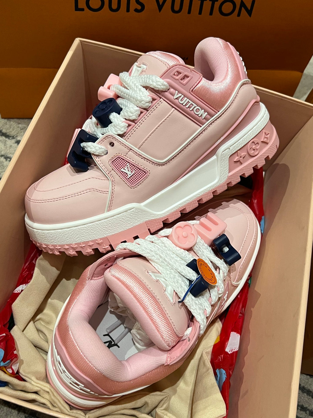 Pink Louis Vuitton low-top sneakers with lace, patch logo, and mint outsole trim