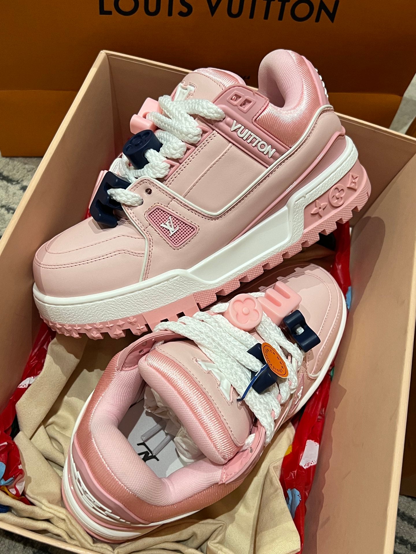 Pink Louis Vuitton low-top sneakers with lace, patch logo, and mint outsole trim