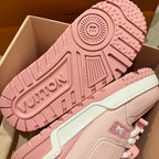 Pink sneaker outsole and heel detail with tread pattern and embossed branding