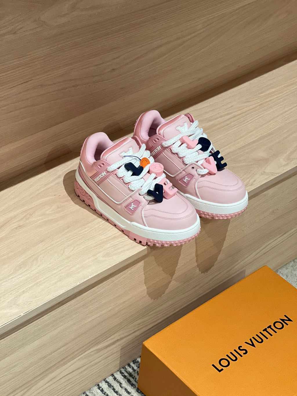 Pair of pink lace-up sneakers with mint accents and chunky white midsole