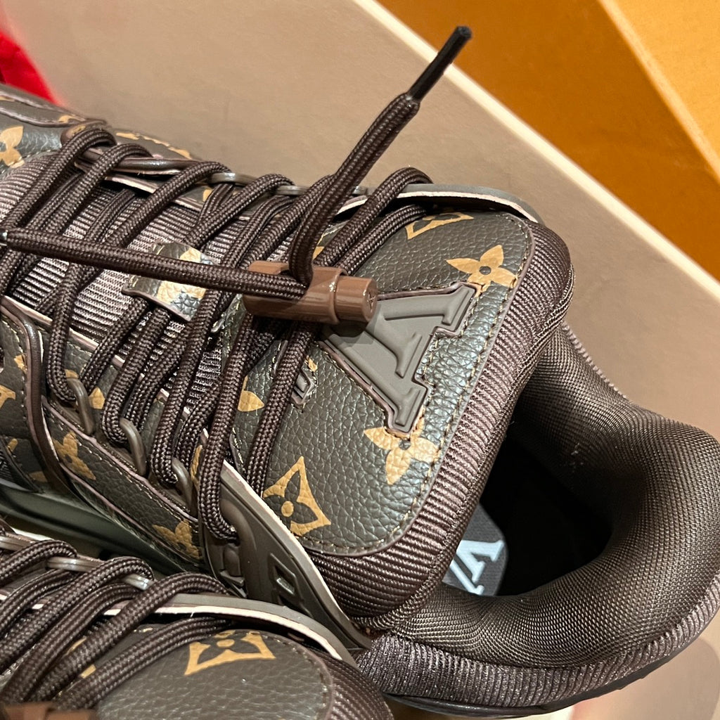 Louis Vuitton monogram trainer shoe close-up of laces and side emblem