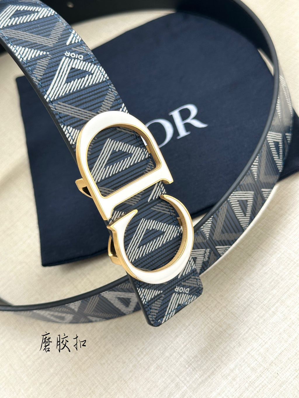 Dior belt close-up: gold CD buckle on blue patterned webbing strap