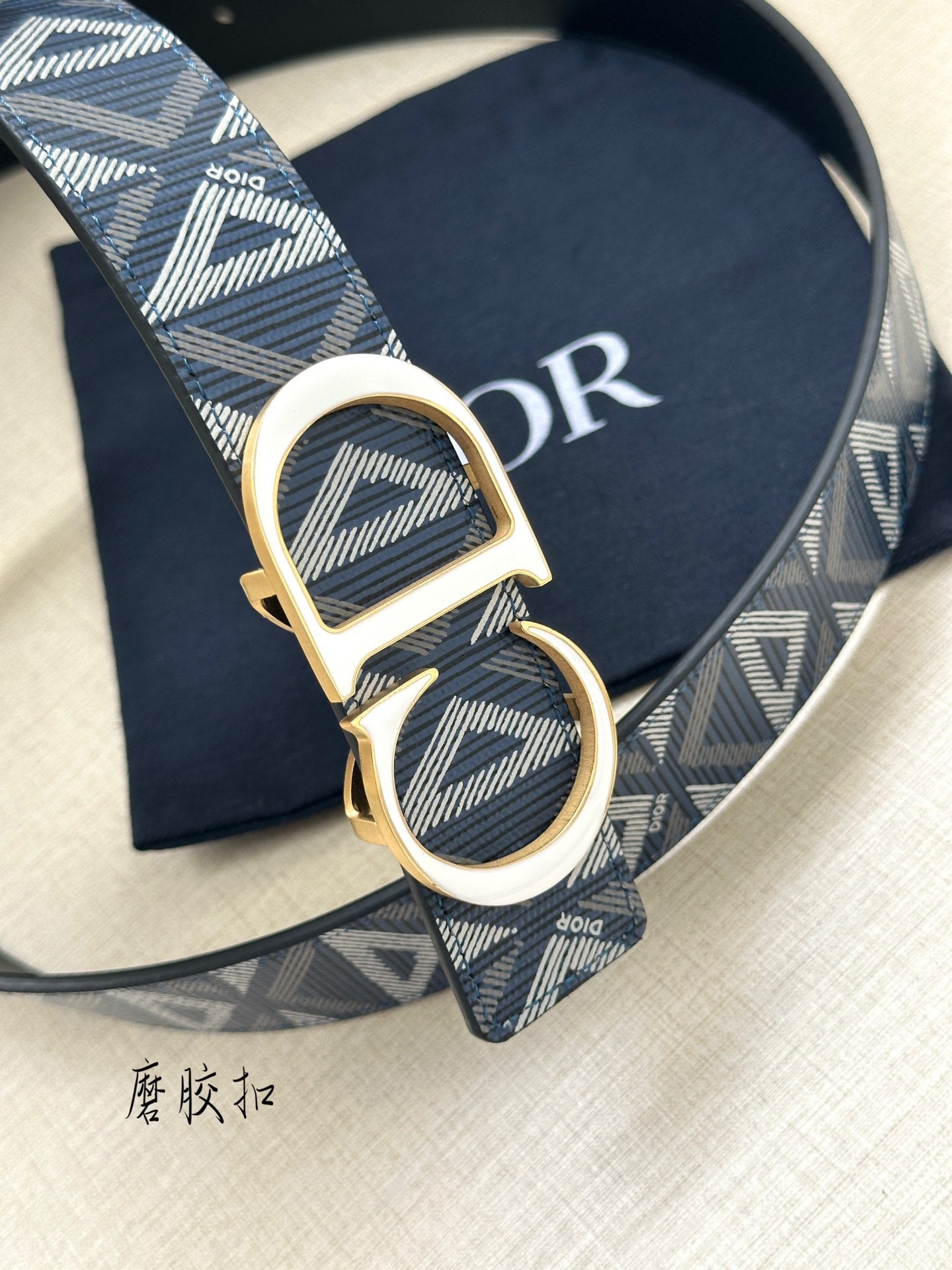 Dior belt close-up: gold CD buckle on blue patterned webbing strap