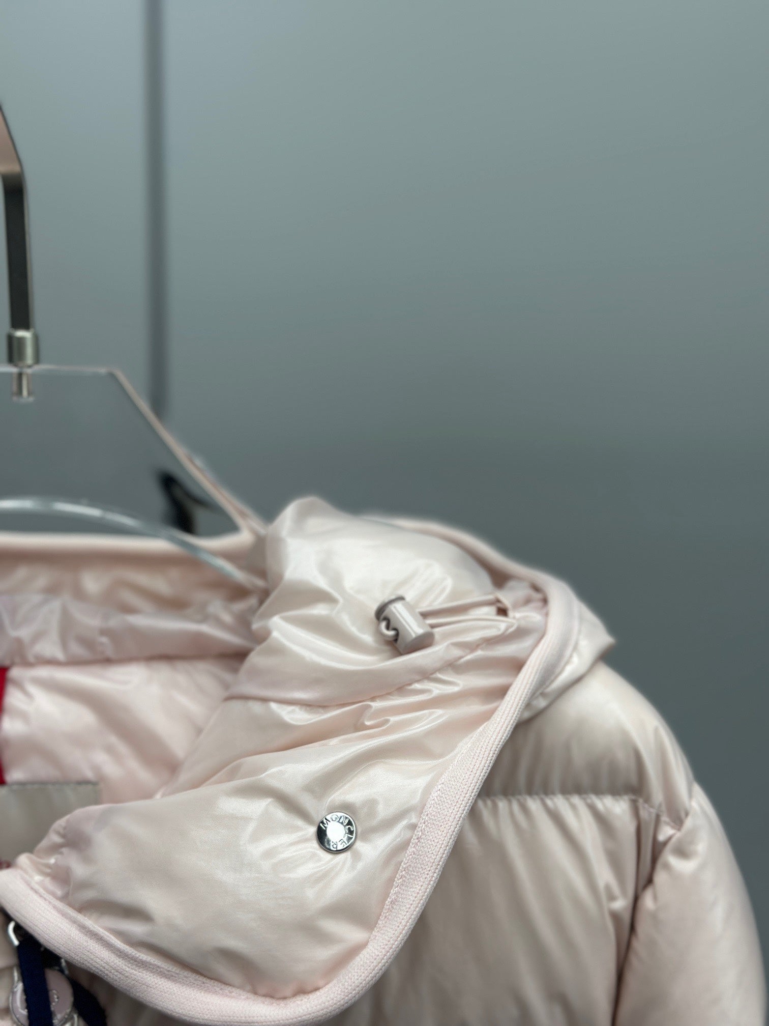 Moncler light pink puffer jacket hood with drawstring and front toggle details