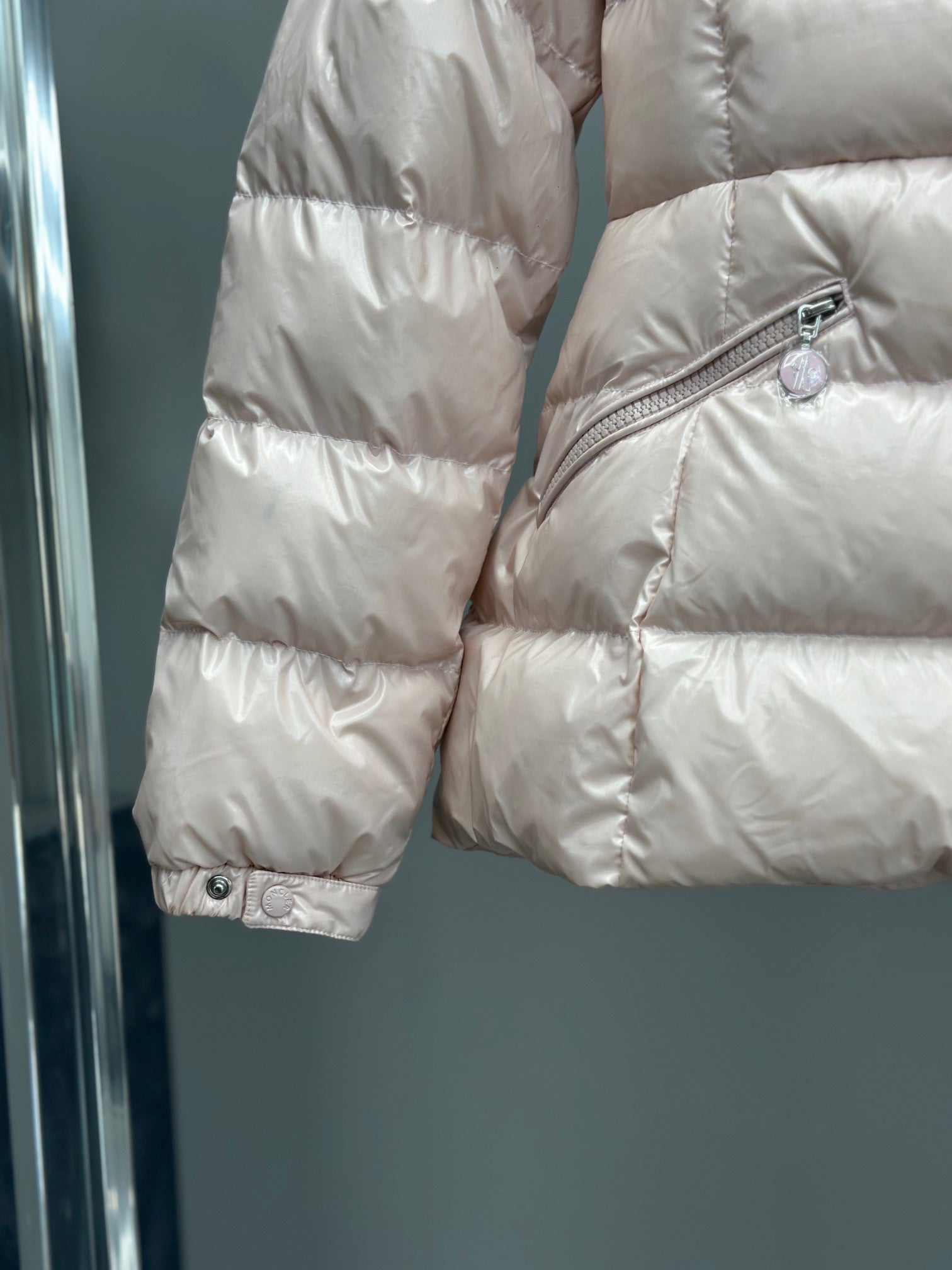 Moncler light pink puffer jacket sleeve with snap cuff and diagonal side zipper